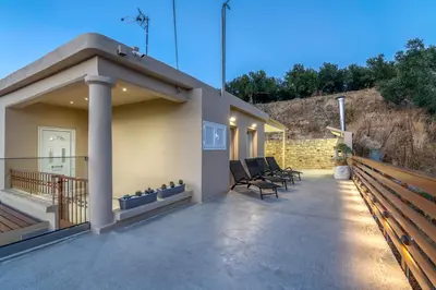a patio of a house with chairs on it at Huzuri Retreat in Kissamos