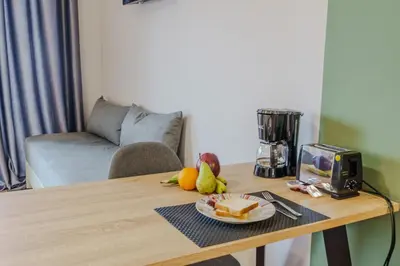 a table with a plate of cheese and fruit on it at Ilios Mare Hotel in Agia Marina Nea Kydonias