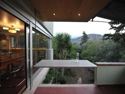a dining table in a house with a view at The Architect's House in Neo Chorio in Néon Khoríon