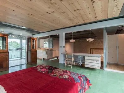 a large room with a bed and a kitchen at The Architect's House in Neo Chorio in Néon Khoríon