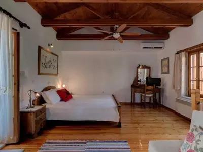 a bedroom with a bed and a ceiling fan at Holiday Home in Douliana mit Großem Balkon by Interhome in Douliana