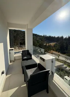 a balcony with two couches and a large window at Villa & Apartament Armonia 2 Sol Aura Gavalochori - Vamos KRETA in Vamos