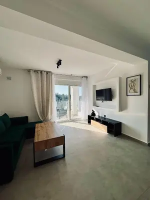 a living room with a couch and a tv at Villa & Apartament Armonia 2 Sol Aura Gavalochori - Vamos KRETA in Vamos