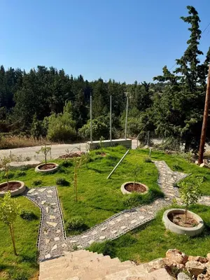 a garden with trees in the middle of a field at Villa & Apartament Armonia 2 Sol Aura Gavalochori - Vamos KRETA in Vamos