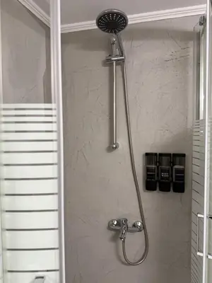 a shower with a shower head in a bathroom at Oneiro Apartment in Kounoupidhianá