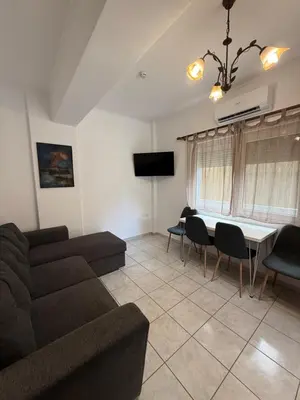 a living room with a couch and a table at Oneiro Apartment in Kounoupidhianá