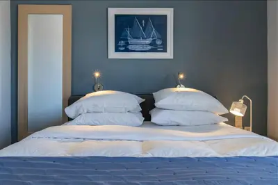 a bedroom with a bed with two pillows at Kafkales Penthouse Chania Old Town in Chania Town