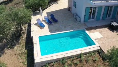 an overhead view of a swimming pool next to a house at villa Elaionas in Tsivarás