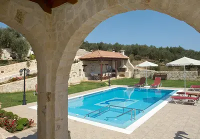 a swimming pool in a villa with an archway at Dream Hill Villas in Tavronitis
