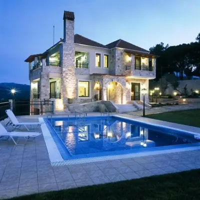 a house with a swimming pool in front of a house at Dream Hill Villas in Tavronitis