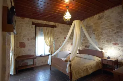a bedroom with a canopy bed with a window at Dream Hill Villas in Tavronitis