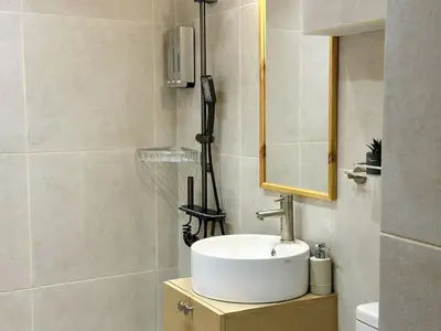a bathroom with a sink and a mirror at Nomas Home, Kalyves Centre Beachfront Sea View in Kalyves