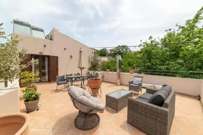 a patio with couches and chairs and a table at 3-Min Drive to Kalyves Beach, Stone Villa in Armenoi next to Cafés & Taverns by the Natural Water Springs in Arménoi