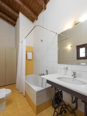 a bathroom with a tub and a sink and a toilet at 3-Min Drive to Kalyves Beach, Stone Villa in Armenoi next to Cafés & Taverns by the Natural Water Springs in Arménoi