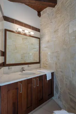 a bathroom with a sink and a mirror at 3-Min Drive to Kalyves Beach, Stone Home with Private Pool in Armenoi Center in Arménoi