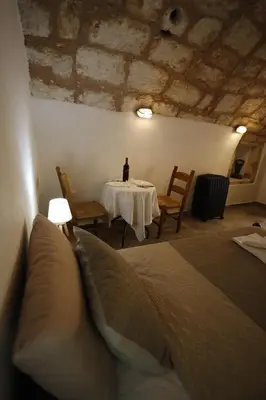 a room with a table with a bottle of wine on it at SternesVillage, Middle Ground Floor in Stérnai