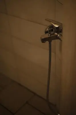 a shower in a bathroom with a shower head at SternesVillage, Middle Ground Floor in Stérnai