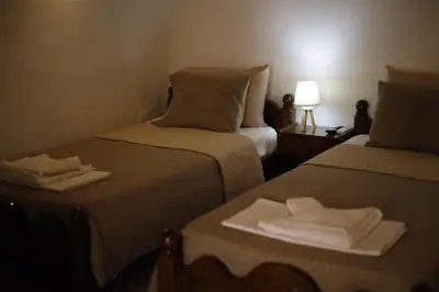 a hotel room with two beds with towels on them at SternesVillage, Middle Ground Floor in Stérnai