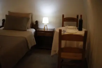 a bedroom with a bed and a table with a lamp at SternesVillage, Middle Ground Floor in Stérnai