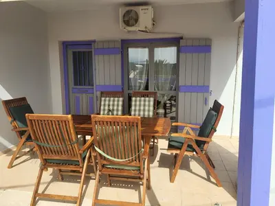 a dining room table with chairs and a table and chairsktop at Aphrodite villa in Darmarochori