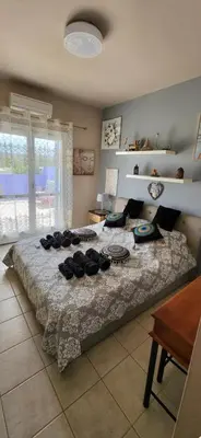 a bedroom with a large bed with hats on it at Aphrodite villa in Darmarochori