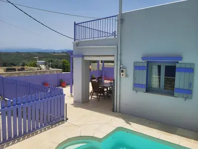 a villa with a swimming pool and a house at Aphrodite villa in Darmarochori