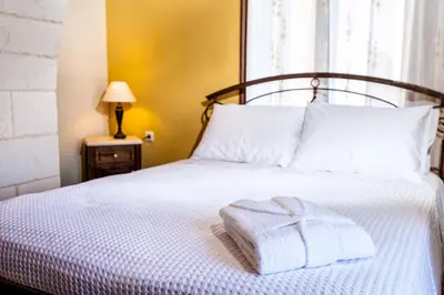 a bedroom with a bed with a towel on it at Villa Eftichia in Stalos