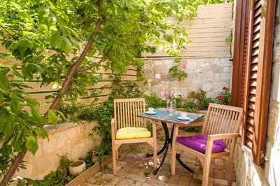 a table and two chairs sitting on a patio at Villa Eftichia in Stalos
