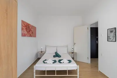a white bedroom with a bed in a room at Cozy Apartment Next To The Beach In Almyrida -BY APOKORONAS VILLAS in Almirida