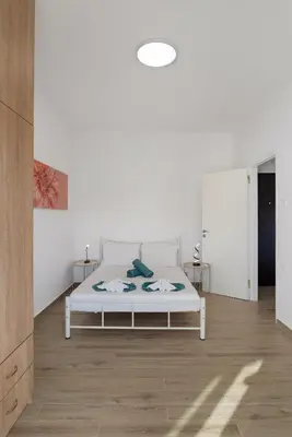 a bedroom with a white bed in a room at Cozy Apartment Next To The Beach In Almyrida -BY APOKORONAS VILLAS in Almirida