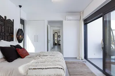 a bedroom with a large bed and a large window at Villa EsHi w Private Pool & Scenic Sea View in Kalyves