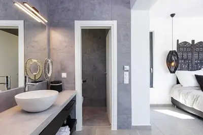 a bathroom with a large bowl sink and a bed at Villa EsHi w Private Pool & Scenic Sea View in Kalyves