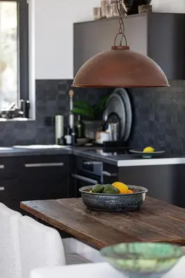 a kitchen with a bowl of fruit on a wooden table at Villa EsHi w Private Pool & Scenic Sea View in Kalyves