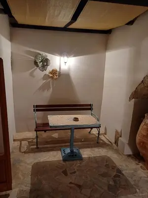 a room with a bench in the corner of a room at Violetta Kaliviani room 1 in Kalivianí