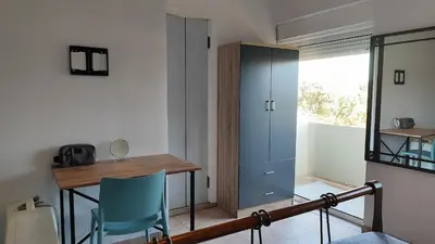 a room with a desk and a table and chairs at John's TownHouse Chania in Tsikalariá