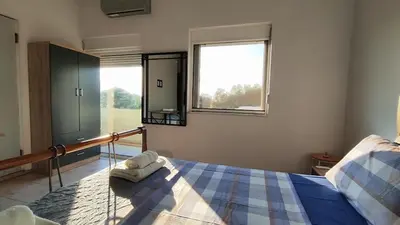 a bedroom with a bed with two towels on it at John's TownHouse Chania in Tsikalariá