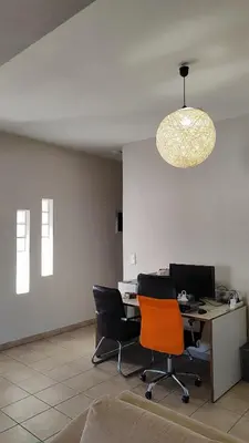 an office with two chairs and a desk with a computer at John's TownHouse Chania in Tsikalariá