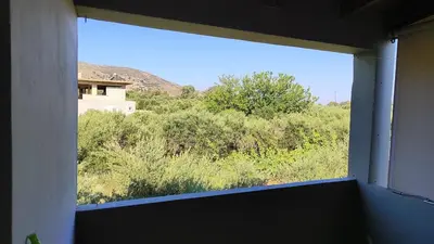 a window in a room with a view of a field at John's TownHouse Chania in Tsikalariá