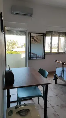 a dining room with a table and two chairs at John's TownHouse Chania in Tsikalariá