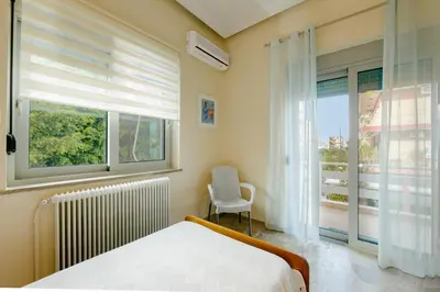 a bedroom with a bed and a window at Leda's Nea Chora Flat, Near Beach and Old Port in Chania Town