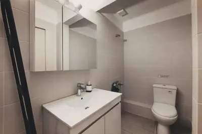 a bathroom with a white sink and a toilet at Leda's Nea Chora Flat, Near Beach and Old Port in Chania Town