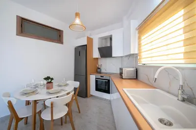 a small kitchen with a table and a sink at KHORA Apartment- 40m to Sandy Beach in Chania Town