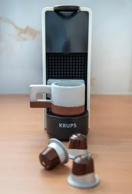 a coffee maker with a cup of coffee and a mouse at KHORA Apartment- 40m to Sandy Beach in Chania Town