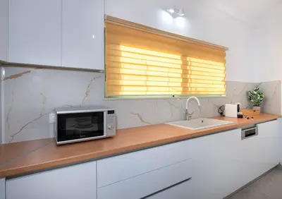 a kitchen counter with a microwave and a sink at KHORA Apartment- 40m to Sandy Beach in Chania Town