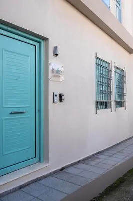 a blue door on the side of a building at KHORA Apartment- 40m to Sandy Beach in Chania Town
