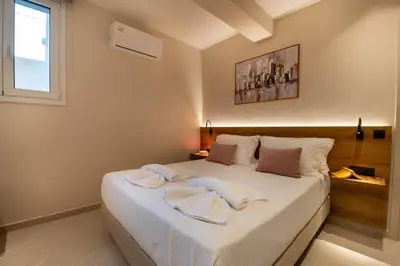 a bedroom with a bed with towels on it at Mystrali I in Galatás