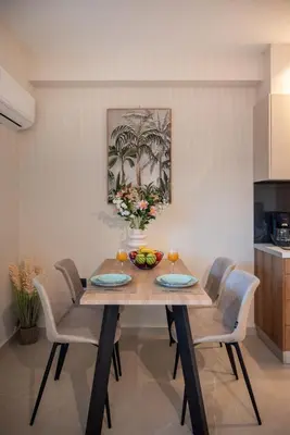 a dining room with a wooden table and chairs at Mystrali I in Galatás