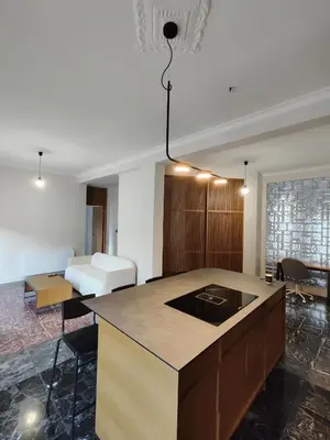 a kitchen with a island in a room with a bed at Apartment Near Beach & Old Port in Chania Town