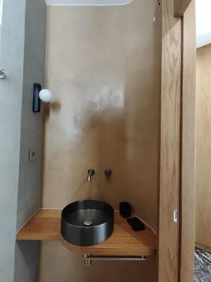a bathroom with a black sink on a wooden shelf at Apartment Near Beach & Old Port in Chania Town
