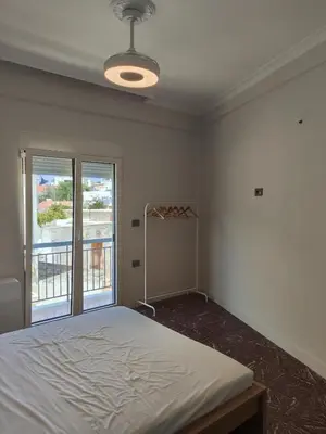 a bedroom with a bed and a large window at Apartment Near Beach & Old Port in Chania Town